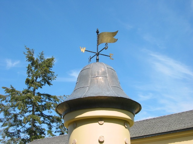 Hand-raised copper cupola with weathervane crowning a Lower Mainland custom home